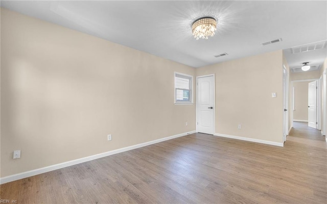 1535 Vine St, Norfolk, VA 23523 - spare room with light wood finished floors, baseboards, and a chandelier