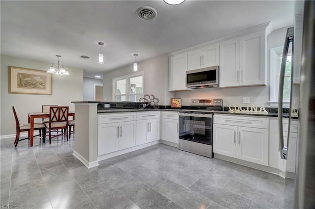116 Odd Rd, Poquoson, VA 23662 - kitchen featuring stainless steel appliances, white cabinets, a chandelier, baseboards, and a peninsula