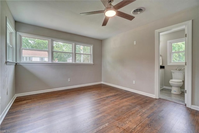 116 Odd Rd, Poquoson, VA 23662 - unfurnished bedroom featuring multiple windows, wood finished floors, baseboards, and a ceiling fan