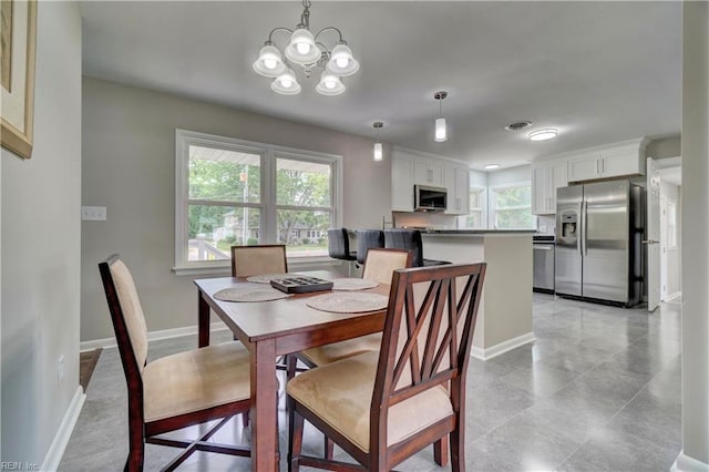 116 Odd Rd, Poquoson, VA 23662 - dining space featuring a chandelier and baseboards