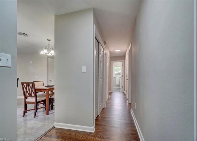 116 Odd Rd, Poquoson, VA 23662 - hallway with a chandelier, dark wood finished floors, and baseboards