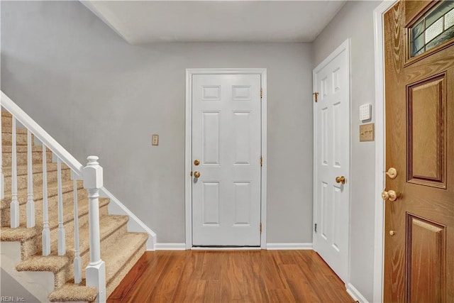 1240 Mozart Dr, Virginia Beach, VA 23454 - foyer entrance with stairway, wood finished floors, and baseboards