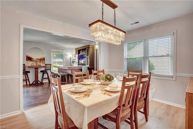 1240 Mozart Dr, Virginia Beach, VA 23454 - dining area featuring light wood-style floors, ornamental molding, a chandelier, and baseboards