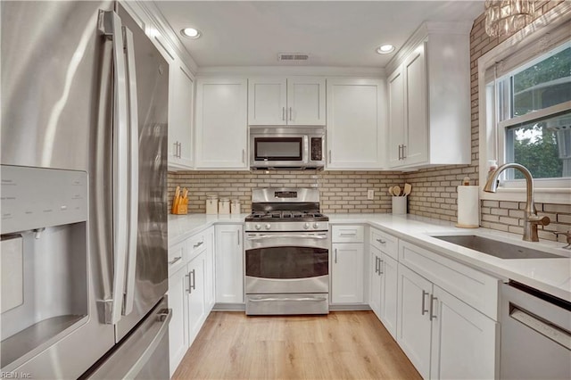 1240 Mozart Dr, Virginia Beach, VA 23454 - kitchen with stainless steel appliances, a sink, white cabinetry, and recessed lighting