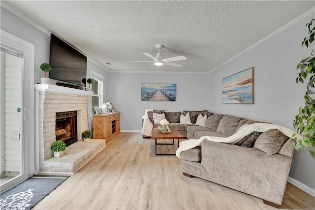 1240 Mozart Dr, Virginia Beach, VA 23454 - living area featuring wood finished floors, ceiling fan, baseboards, ornamental molding, and a fireplace