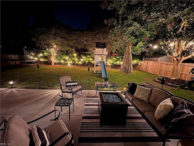 1240 Mozart Dr, Virginia Beach, VA 23454 - patio at twilight featuring a playground, a trampoline, a patio area, and an outdoor living space with a fire pit