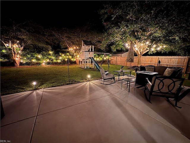 1240 Mozart Dr, Virginia Beach, VA 23454 - patio at night with an outdoor fire pit, a playground, and a patio area