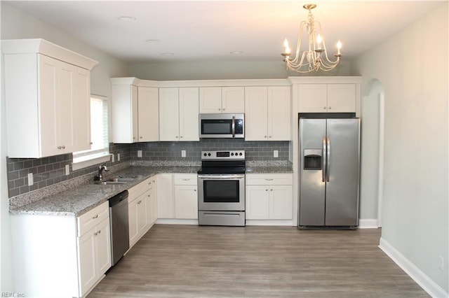 1158 Virginia Ave, Chesapeake, VA 23324 - kitchen featuring stainless steel appliances, a chandelier, and white cabinetry