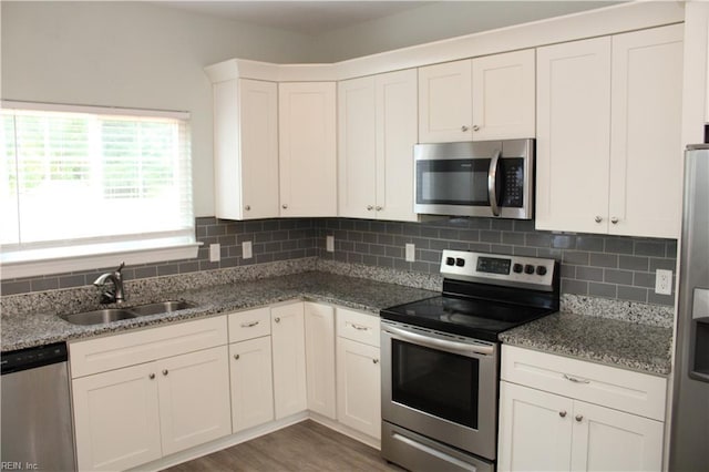 1158 Virginia Ave, Chesapeake, VA 23324 - kitchen with stainless steel appliances, a sink, tasteful backsplash, white cabinets, and light stone counters