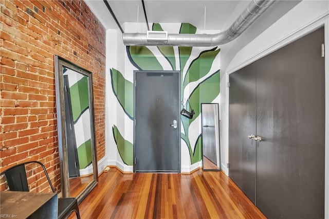 111 W Tazewell St Unit 200, Norfolk, VA 23510 - unfurnished room featuring wood finished floors, brick wall, and baseboards