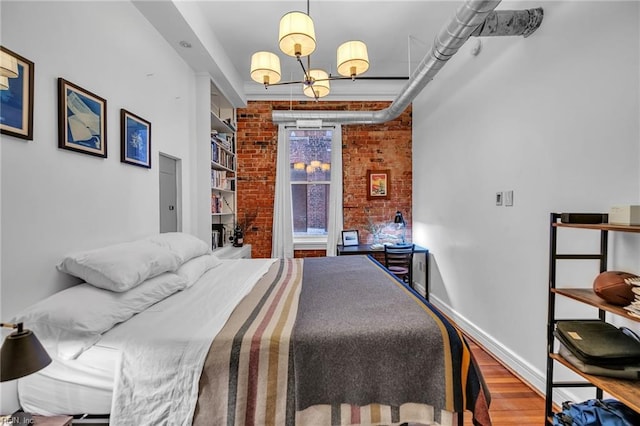 111 W Tazewell St Unit 200, Norfolk, VA 23510 - bedroom featuring brick wall, wood finished floors, and baseboards