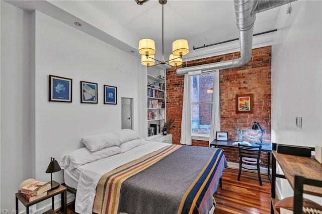 111 W Tazewell St Unit 200, Norfolk, VA 23510 - bedroom with brick wall, wood finished floors, and a chandelier