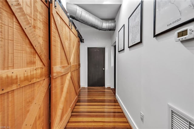 111 W Tazewell St Unit 200, Norfolk, VA 23510 - corridor featuring a barn door, wood finished floors, and baseboards