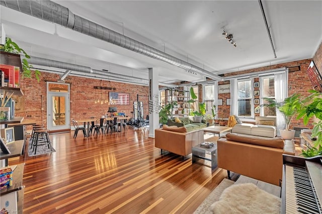 111 W Tazewell St Unit 200, Norfolk, VA 23510 - living room featuring brick wall, wood finished floors, and rail lighting