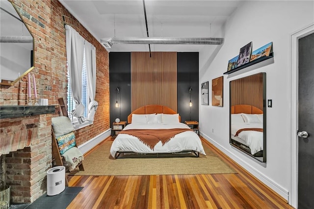 111 W Tazewell St Unit 200, Norfolk, VA 23510 - bedroom featuring wood finished floors, brick wall, and baseboards