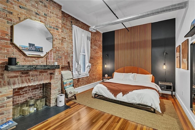 111 W Tazewell St Unit 200, Norfolk, VA 23510 - bedroom with hardwood / wood-style floors, brick wall, and baseboards