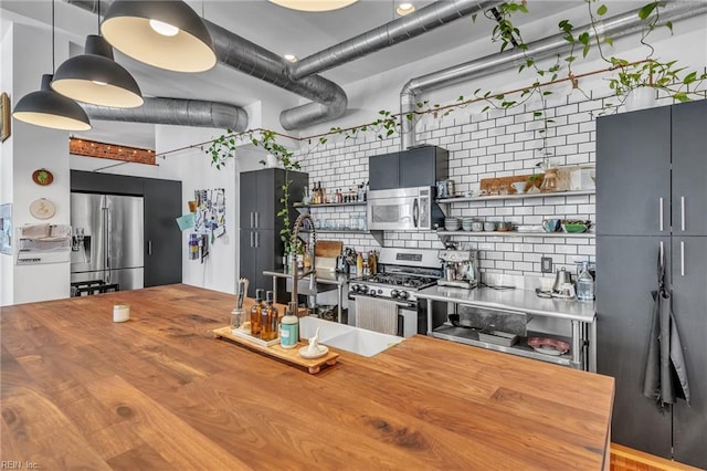 111 W Tazewell St Unit 200, Norfolk, VA 23510 - kitchen featuring wood counters, appliances with stainless steel finishes, open shelves, and backsplash