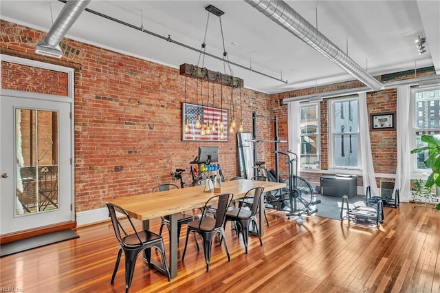 111 W Tazewell St Unit 200, Norfolk, VA 23510 - dining room featuring wood-type flooring, brick wall, and baseboards