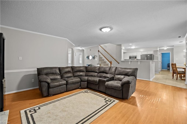 1244 Bell Tower Arch, Chesapeake, VA 23324 - living area featuring light wood finished floors, stairs, a textured ceiling, baseboards, and ornamental molding