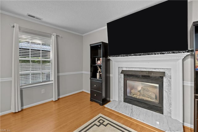 1244 Bell Tower Arch, Chesapeake, VA 23324 - unfurnished living room featuring light wood finished floors, a high end fireplace, a textured ceiling, ornamental molding, and baseboards