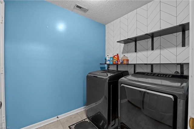 1244 Bell Tower Arch, Chesapeake, VA 23324 - laundry room with washing machine and dryer, a textured ceiling, baseboards, and tile patterned flooring