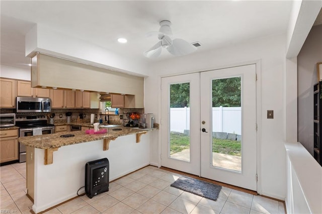 2389 Kerr Dr, Virginia Beach, VA 23454 - kitchen featuring stainless steel appliances, french doors, a peninsula, tasteful backsplash, and recessed lighting