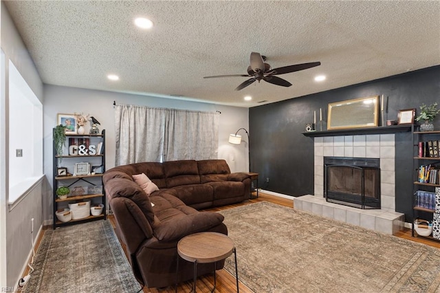 2389 Kerr Dr, Virginia Beach, VA 23454 - living room with ceiling fan, recessed lighting, a textured ceiling, a fireplace, and wood finished floors