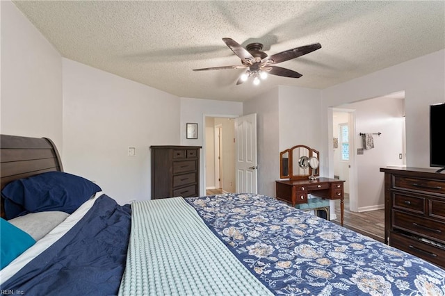 2389 Kerr Dr, Virginia Beach, VA 23454 - bedroom with wood finished floors, a textured ceiling, baseboards, and ceiling fan