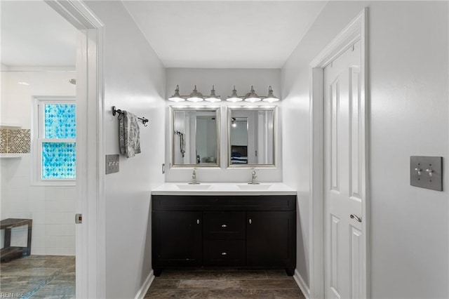 2389 Kerr Dr, Virginia Beach, VA 23454 - bathroom featuring double vanity, wood finished floors, and baseboards