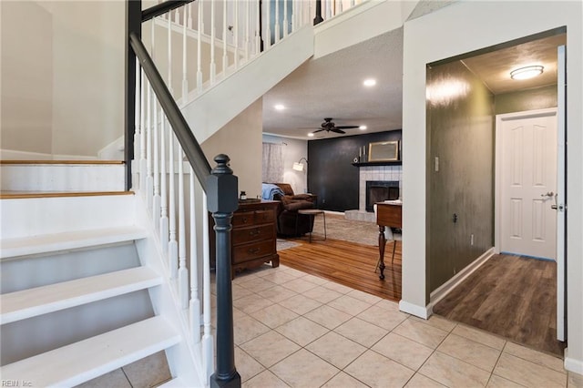 2389 Kerr Dr, Virginia Beach, VA 23454 - staircase featuring tile patterned flooring, a ceiling fan, a fireplace, baseboards, and recessed lighting