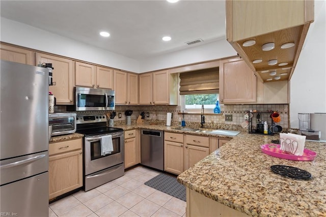 2389 Kerr Dr, Virginia Beach, VA 23454 - kitchen with appliances with stainless steel finishes, a sink, light brown cabinets, backsplash, and recessed lighting
