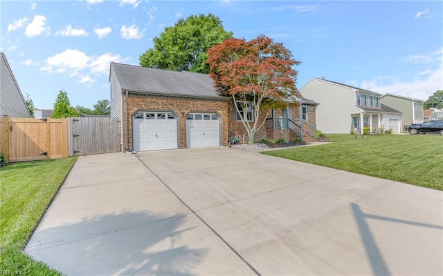 1213 Mozart Dr, Virginia Beach, VA 23454 - view of front of property featuring a gate, brick siding, concrete driveway, a front yard, and a garage