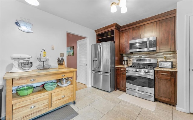 1213 Mozart Dr, Virginia Beach, VA 23454 - kitchen with appliances with stainless steel finishes, decorative backsplash, light tile patterned floors, and light countertops