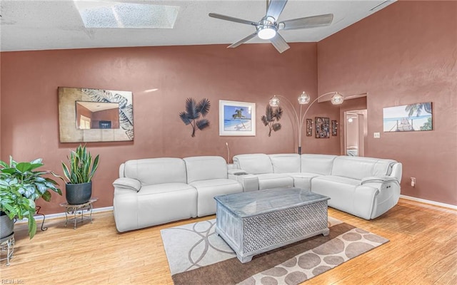 1213 Mozart Dr, Virginia Beach, VA 23454 - living room with wood finished floors, a skylight, ceiling fan, baseboards, and vaulted ceiling