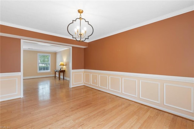 6 Elite Ct, Hampton, VA 23666 - unfurnished room featuring a chandelier, light wood-style flooring, a wainscoted wall, a decorative wall, and crown molding