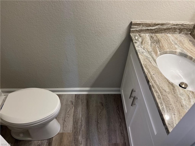 420 Webb St, Suffolk, VA 23434 - bathroom with a textured wall, vanity, wood finished floors, baseboards, and toilet