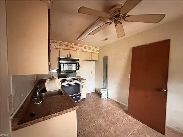 1649 Cardigan St, Chesapeake, VA 23324 - kitchen featuring white electric range, black oven, a sink, a ceiling fan, and light tile patterned flooring