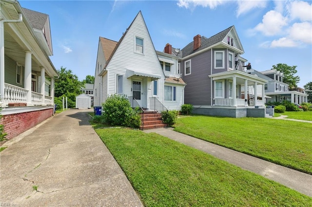 2718 Chesterfield Blvd, Norfolk, VA 23504 - view of front of house featuring covered porch, a residential view, a front yard, and concrete driveway