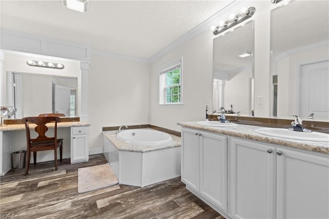 35220 Seacock Chapel Rd, Zuni, VA 23898 - bathroom featuring double vanity, crown molding, wood finished floors, a textured ceiling, and a garden tub