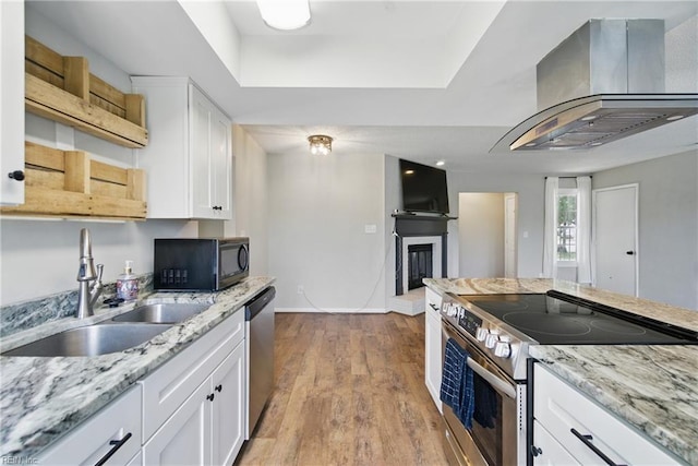 1305 Ettington Ln, Virginia Beach, VA 23464 - kitchen featuring stainless steel appliances, island exhaust hood, white cabinets, and a sink