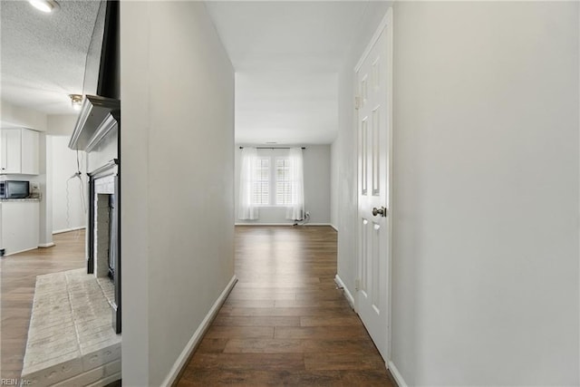 1305 Ettington Ln, Virginia Beach, VA 23464 - hall featuring dark wood-type flooring, baseboards, and a textured ceiling