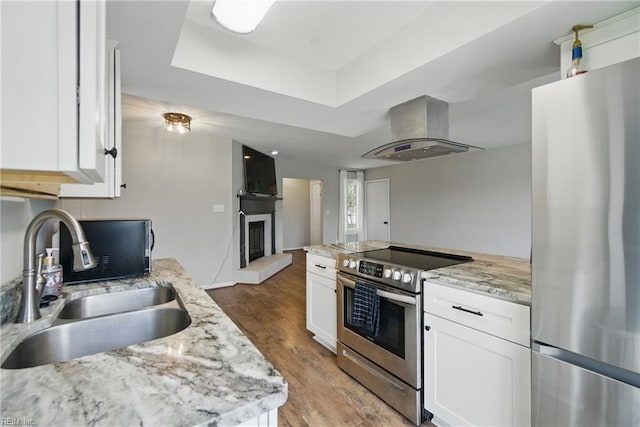 1305 Ettington Ln, Virginia Beach, VA 23464 - kitchen featuring appliances with stainless steel finishes, island exhaust hood, a sink, and white cabinetry