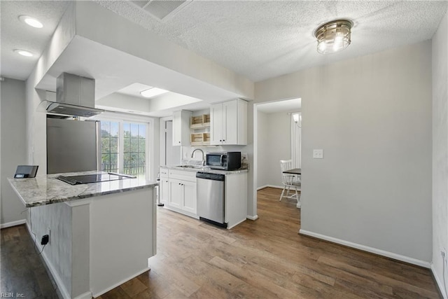 1305 Ettington Ln, Virginia Beach, VA 23464 - kitchen with stainless steel appliances, white cabinetry, wood finished floors, and a textured ceiling