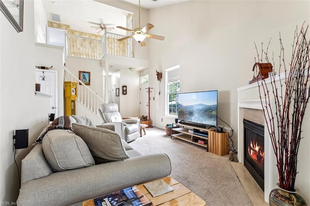 113 Trevor Trce, Yorktown, VA 23692 - living area featuring stairway, a high end fireplace, a ceiling fan, a towering ceiling, and carpet