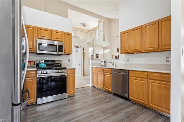 113 Trevor Trce, Yorktown, VA 23692 - kitchen with stainless steel appliances, a high ceiling, wood finished floors, light countertops, and ceiling fan