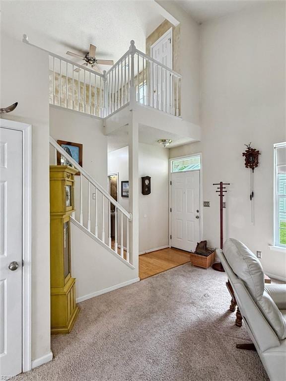 113 Trevor Trce, Yorktown, VA 23692 - foyer with carpet flooring, a high ceiling, a ceiling fan, and stairs