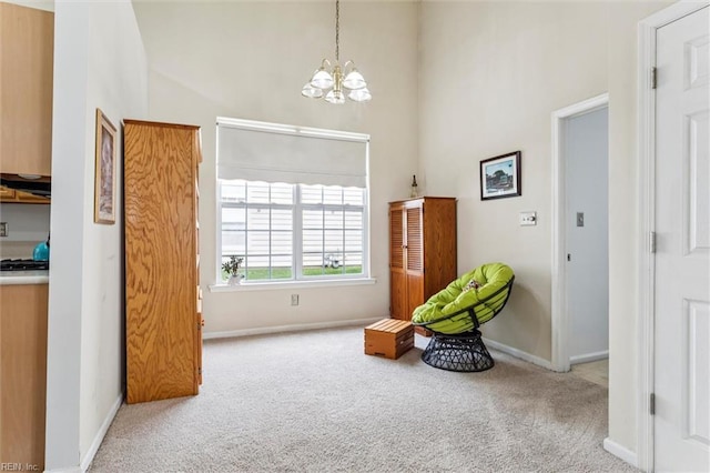 113 Trevor Trce, Yorktown, VA 23692 - sitting room with carpet floors, a chandelier, and a towering ceiling