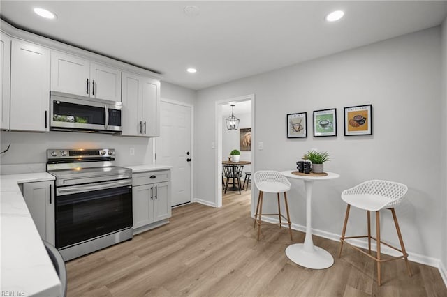 13 Cortez Ct, Hampton, VA 23666 - kitchen featuring appliances with stainless steel finishes, baseboards, light wood-style flooring, recessed lighting, and white cabinetry