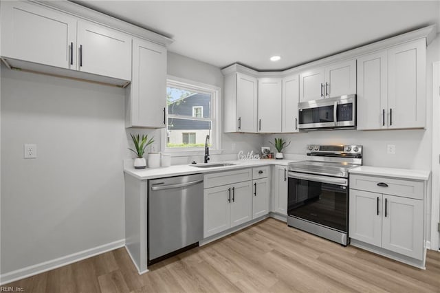 13 Cortez Ct, Hampton, VA 23666 - kitchen featuring appliances with stainless steel finishes, a sink, light wood-style floors, light countertops, and recessed lighting