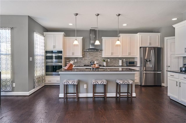 604 Baker Loop, Chesapeake, VA 23320 - kitchen featuring stainless steel appliances, wall chimney range hood, decorative backsplash, white cabinets, and recessed lighting